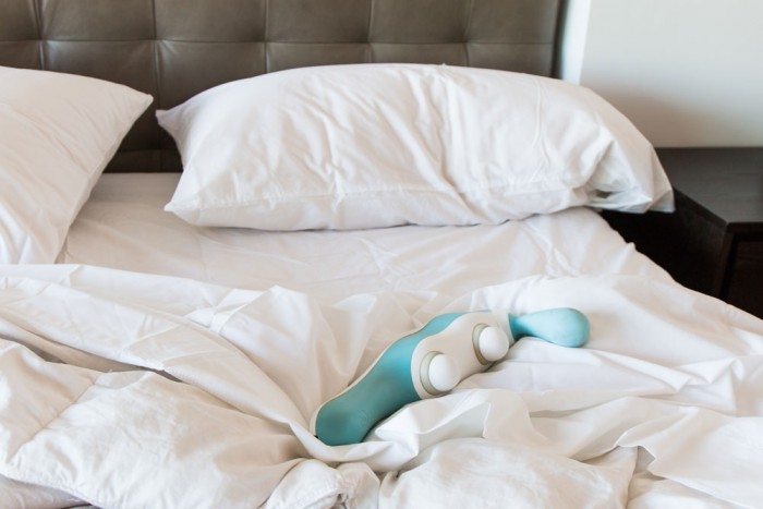 hi massager sex toy on bed